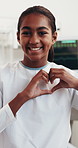 Face, child and smile in hospital with heart hands, emoji and trust medical treatment for recovery. Happy, girl and patient in pediatric clinic with love symbol, wellness and healing from disease.