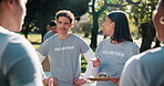 Team, leader and volunteer in park with meeting, charity briefing or task delegation with people. Happy, motivation and clipboard with schedule or agenda for humanitarian aid or community outreach