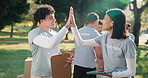 Volunteer, high five and tablet for teamwork outdoor in park for donation, charity work or success. Woman, man and happy to celebrate online review, sponsor and clipboard for community outreach