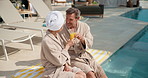 Happy, toast and couple by pool with drink for vacation, holiday and bonding on weekend getaway. Marriage, relax and man with woman cheers with mimosa, alcohol and juice for love, break and travel