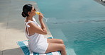 Vacation, relax and woman at swimming pool with drink, sunglasses and chill by water in summer. Poolside, cocktail and person on holiday at luxury resort, travel or sunbathing outdoor with shades