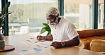 Mature, finance and black man with documents in home for investment statistics, profit or revenue. Male person, analysis or remote work with paperwork for analytics, budget planning or house expenses