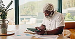 Mature, finance and black man with tablet in home for asset management, audit or investment. Documents, male person or financial planning with technology for budget, expenses or analytics in house