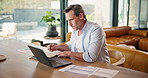 Mature, man and laptop with finance in home for budget planning, asset management or expenses. Male person, documents or financial audit with computer, notebook or diary for investment in house