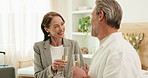 Smile, couple and cheers at hotel with alcohol, guest arrival and celebration for romantic holiday. Happy, mature people or toast at resort with champagne, complimentary gift and anniversary vacation