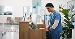 Nurse, man and computer at hospital reception with schedule, review online booking and appointment. Medical worker, person and typing at clinic front desk with pc, healthcare administration and plan.