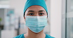 Face mask, surgeon and woman in hospital for hygiene, wellness and safety compliance. Portrait, medical professional and healthcare with ppe, scrubs and surgery employee for support in clinic