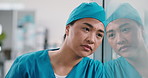 Upset, woman and nurse with stress on glass window for medical failure, mistake or bad procedure. Disappointed, female person or health surgeon with reflection for surgical crisis or loss in hospital