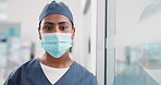 Face mask, surgeon and woman in hospital for healthcare, wellness and safety compliance. Portrait, medical professional and security with ppe, scrubs and surgery employee for support in clinic