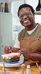 Happy man, face and paint in pottery studio, craftsmanship and laugh with handmade bowl in workshop. Artisan, portrait and black person with glasses, art and smile with ceramic sculpture in startup