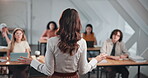 College, education and lecturer with students in classroom, lesson and explain assignment to group. Professor, back and people with technology, knowledge and advice for academic growth in university