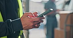 Typing, phone and hands of man for delivery, supply chain and courier service for package at depot. Scroll, parcel and person on cellphone for online update for shipping, logistics and distribution