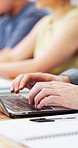 Typing, hands and student on laptop in classroom for learning, lesson and online notes for course. University, computer and person in lecture for education, knowledge and studying for assignment
