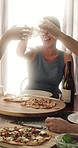 Woman, friends and cheers in home with wine, pizza and bonding together for celebration of reunion. Happy, people and toast in dining room with alcohol drink, food and social gathering for wellness.