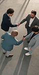 People, architect and meeting in office with handshake, welcome and partnership for renovation. Above, team and shaking hands at site for introduction, agreement and onboarding for building expansion