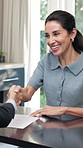 Success, woman and realtor in home with handshake, contract and agreement in property transaction. Happy, broker and mature client with shaking hands, ownership transfer and deal on housing purchase.