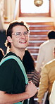 College, face and man on campus with smile, knowledge and scholarship pride in study opportunity. Happy, gen z and university student with laugh, higher education and confidence in academic course.