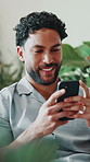 Laugh, phone and man in lounge with message, online communication and comic post on social media. Digital, contact and happy person in house with technology, funny text and meme reaction on chat app.