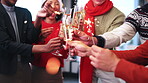Hands, christmas and cheers with sparklers in office for festive celebration or December together. People, employees or champagne with fireworks for new year event or social gathering in workplace