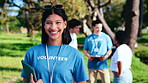 Volunteer, face and happy woman in park for outdoor charity or community service together. Portrait, female person or NGO with smile or tablet for social responsibility or team outreach in nature