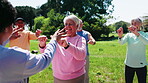 Fitness, coach or old people outdoor with hand exercise, active aging or group for workout. Grip strength, park or senior friends and personal trainer, happy or wellness class for retirement activity