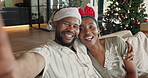 Christmas, selfie and happy black couple together on home sofa for bonding, quality time and love. Man, woman or festive season in house with social media, commitment and holiday celebration post