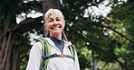 Face, smile and old woman hiking in nature with fitness, travel or fresh air for retirement wellness. Bokeh, happy senior person and journey outdoor in forest with trekking, vitality and good mood.