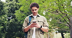 Man, walk and outdoor at college with phone, check social media post and email for higher education. Student, person and journey in park with tech, university portal and online learning platform.