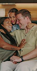 Happy, parents and child in living room with hug, kiss and quality time together for weekend break. Face, mother and father in home with daughter, embrace and affection for interracial family bonding
