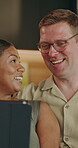 Couple, connection and laughing with tablet, home and watching movie with subscription in lounge. Interracial, marriage and happy people with tech, love or streaming funny video with partner in house