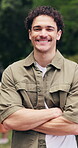 Face, man and happy at park with arms crossed, holiday chill and relax in nature with free time. Wellness, confident person or smile outdoor for weekend break, fresh air or contentment on solo outing