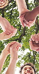 Smile, students and holding hands outdoor for education, support and motivation for new semester. Below, people and huddle in nature for friendship, acceptance and study group of academic achievement