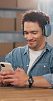 Logistics, man and headphones in small business with phone, streaming music and check app for order. Happy, person and ecommerce in startup with audio tech, track courier online and listen to radio.