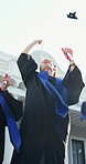 Students, throwing and cap outdoor at graduation, diploma and achievement for degree completion. People, tossing and hats at campus for celebration, academic success and award for learning milestone