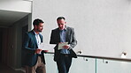 Walking, meeting and men on tablet in lobby for planning, finance review and investor update. Manager, business and people with tech, paperwork and financial report for budget, proposal and talking