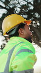Thinking, construction and back of man with helmet for planning, inspection and remodeling project. Civil engineering, architecture and person with ppe, safety gear and idea for renovation outdoor
