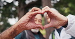 Hands, old couple and love in nature for hiking, romance and appreciation for trekking getaway. Face, smile and senior people in woods with heart gesture, partner affection and backpacking vacation