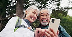 Hiking, break and old couple in nature with phone, conversation or search route for adventure trip. Happy, senior people and check location outdoor with tech, relationship or digital map for trekking