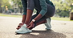 Hands, shoelace and tie in park for exercise start, preparation or runner getting ready for training. Active, woman and secure sneakers outdoor for fitness, wellness and safety for beginning workout.