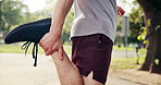 Legs, fitness and person stretching at park for blood circulation, workout preparation or health. Outdoor runner, warm up muscle and man getting ready to start exercise with hands for wellness