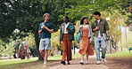 Students, walk and outdoor in university with conversation, hangout and advice for exam preparation. Happy, people and discussion in park with bonding together, study tips and college for education.