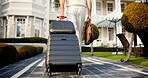 Holiday, entry or legs at resort with suitcase, travel reservation or accommodation for getaway trip. Walking, back or man in lodge with luggage, hotel booking or guest arrival for summer vacation.