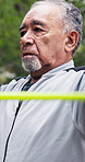 Breathe, fitness and old man outdoor with resistance band, exercise and muscle strength in park. Physio, retirement and senior person with equipment and stretching for workout, mobility and wellness