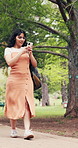 Walking, phone and woman outdoor at college for social media, chat or travel to class for education. Happy, university and student on cellphone for internet, website and message for learning or study