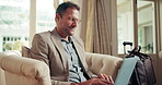 Laptop, typing and travel with business man in hotel for conference itinerary, research and report. Corporate retreat, vip event and tradeshow hospitality with mature employee and smile for update