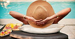 Hat, woman and stretching poolside for holiday unwind, solo travel and luxury getaway at resort. Back, person and relax at swimming pool  for vacation downtime, hotel staycation or peaceful afternoon