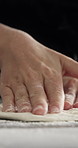 Person, hands and flour with dough on table for culinary art, hospitality or meal prep for pizza. Closeup, pastry chef or food artist with ingredients, sprinkle or texture for recipe or cuisine