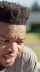 Fitness, tired and black man with break in nature for outdoor exercise, cardio training or running. Exhausted, male person, or runner breathing in fatigue for rest, recovery or vitality in park