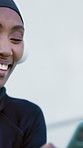 Black woman, headphones and phone in city for fitness, streaming and podcast for exercise break. Smile, muslim person and relax outdoor with mobile, listening to music and download audio for training