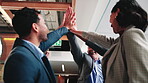 Happy people, high five and partnership in office, success and solidarity for legal service or case. Lawyers, applause and collaboration with colleagues, low angle and celebration for achievement